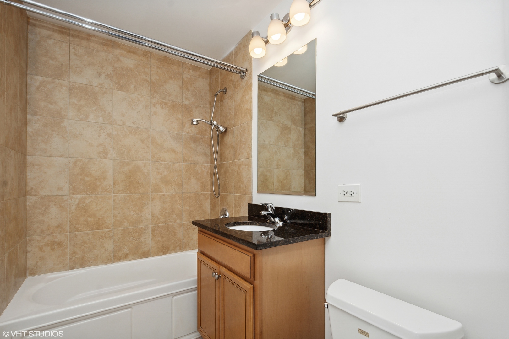 1791 West Howard Street, Unit 504 Chicago, IL 60626 - Photo 17 of 23 a bathroom with a granite countertop sink a toilet and shower