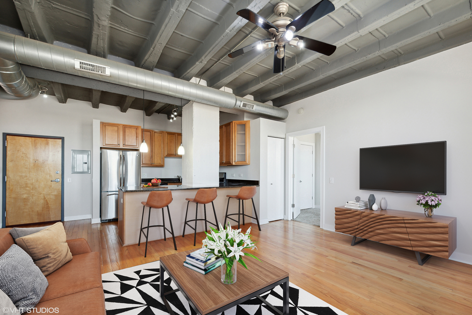 1791 West Howard Street, Unit 504 Chicago, IL 60626 - Photo 3 of 23 a living room with furniture and a flat screen tv