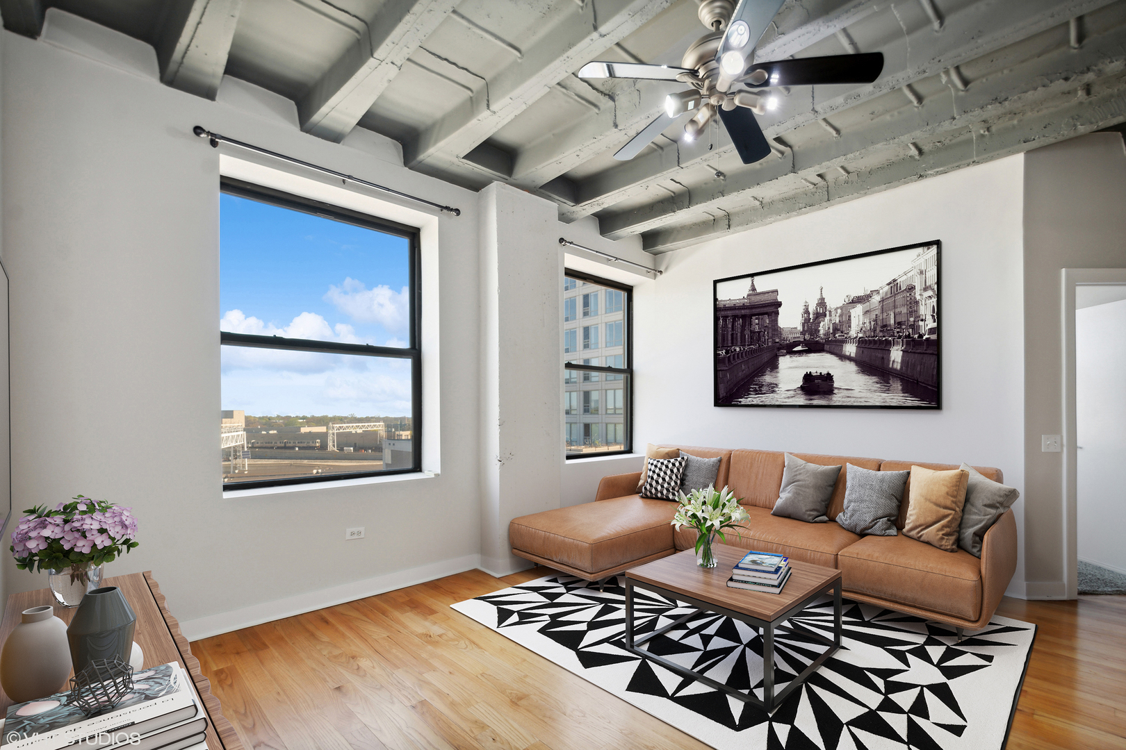 1791 West Howard Street, Unit 504 Chicago, IL 60626 - Photo 5 of 23 a living room with furniture a rug and a chandelier
