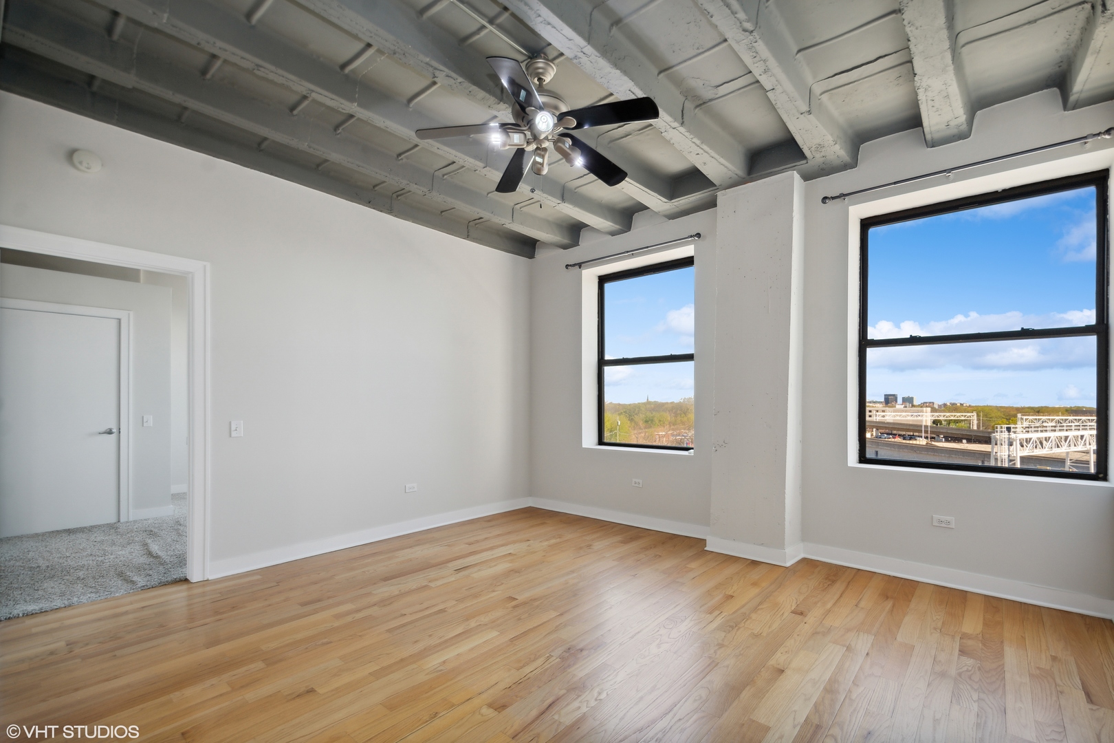 1791 West Howard Street, Unit 504 Chicago, IL 60626 - Photo 7 of 23 a view of an empty room with a window and wooden floor