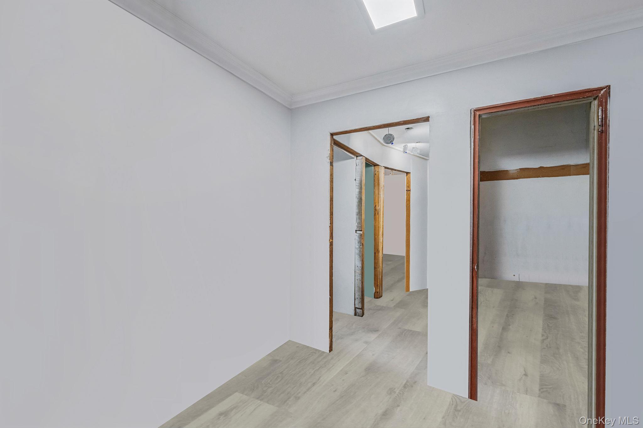 179-49 Eveleth Road Queens, NY 11434 - Photo 12 of 17 a view of a hallway with wooden floor