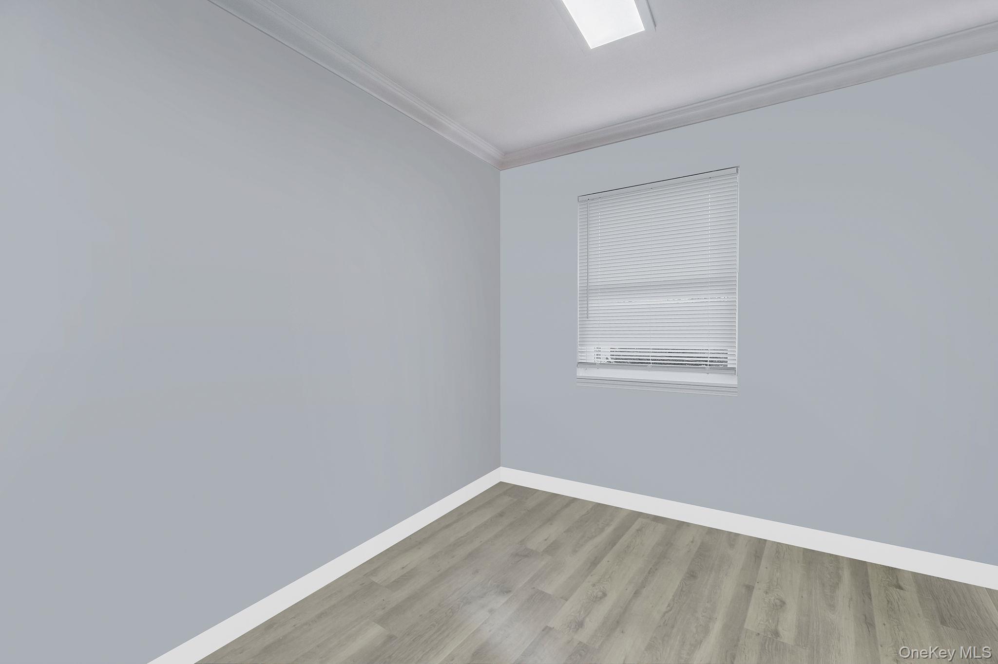 179-49 Eveleth Road Queens, NY 11434 - Photo 14 of 17 a view of an empty room with wooden floor and a window