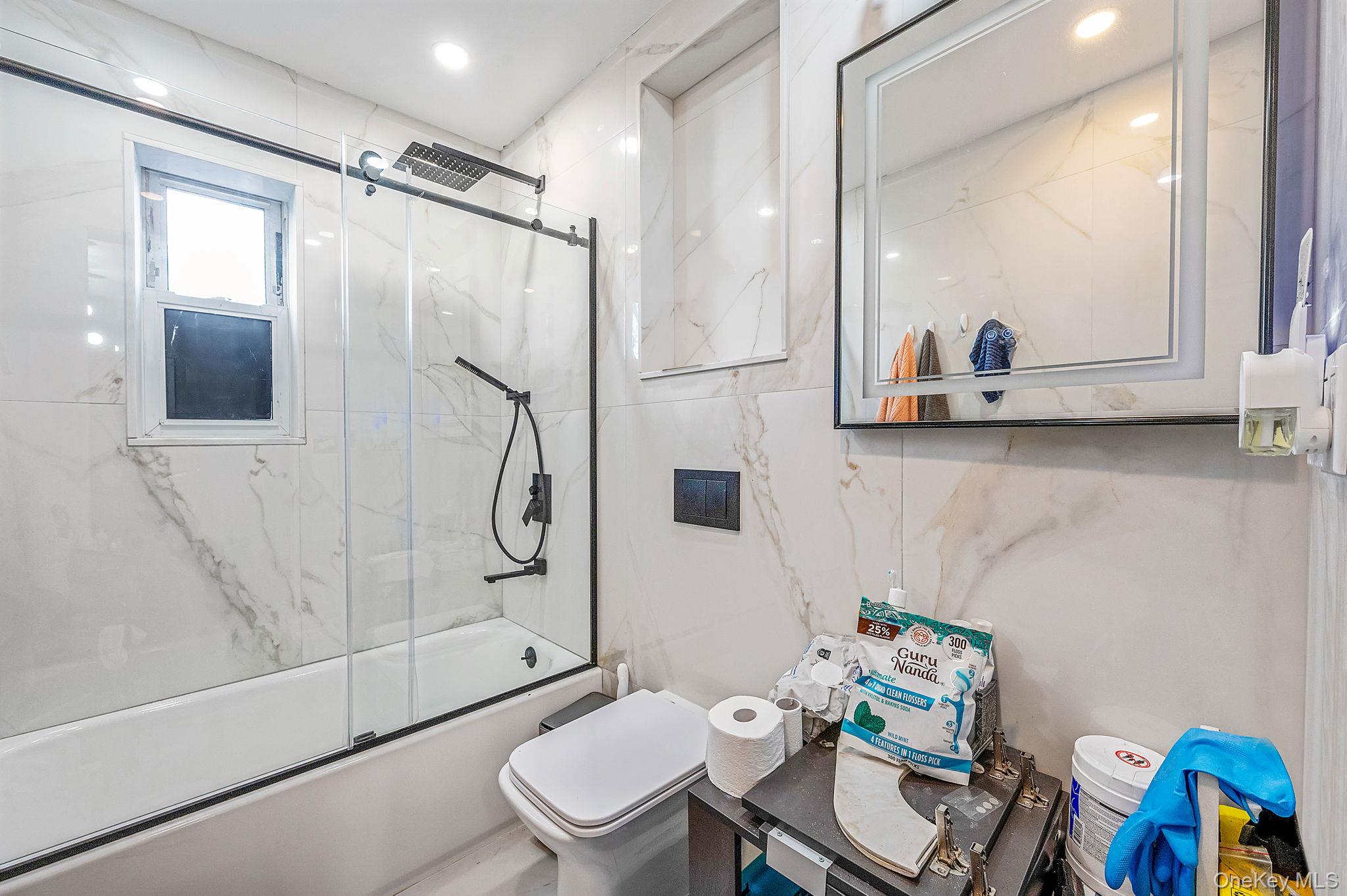 179-49 Eveleth Road Queens, NY 11434 - Photo 8 of 17 a bathroom with a toilet a sink and a shower