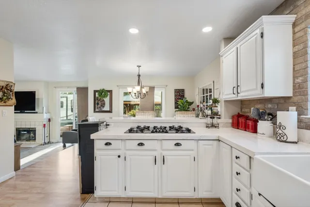 a kitchen with stainless steel appliances granite countertop a sink stove and cabinets