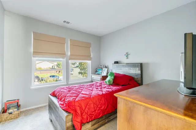 a bedroom with a bed and window