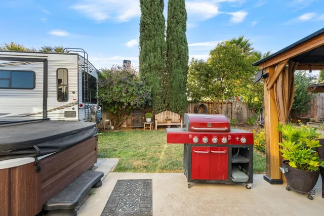 a view of a chairs and table in the back yard of the house