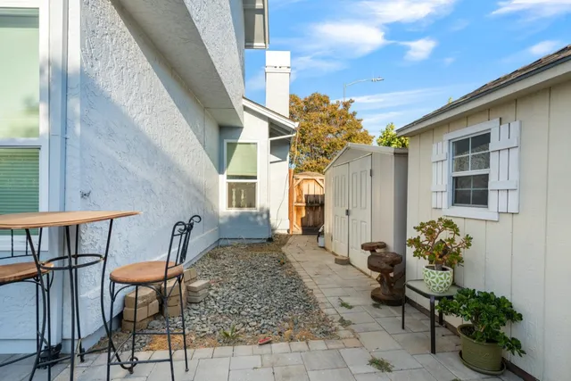 a view of a house with backyard and sitting area