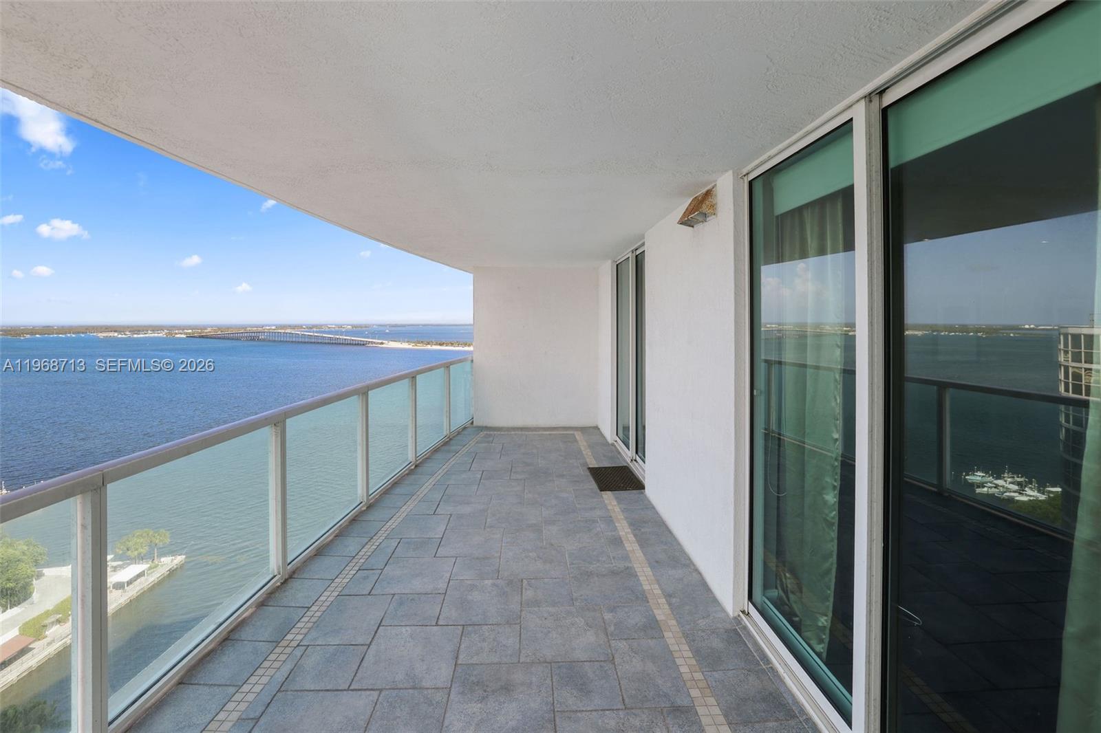 2101 Brickell Avenue, Unit 1704 Miami, FL 33129 - Photo 12 of 19 a hallway with sliding door and yard in back