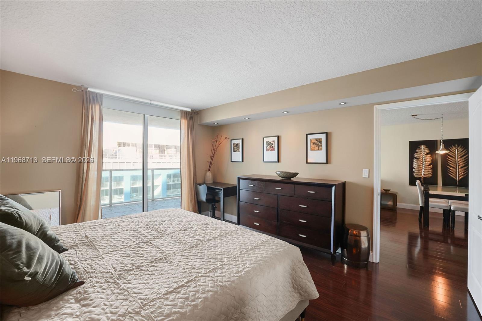 2101 Brickell Avenue, Unit 1704 Miami, FL 33129 - Photo 16 of 19 a bedroom with a bed and wooden floor