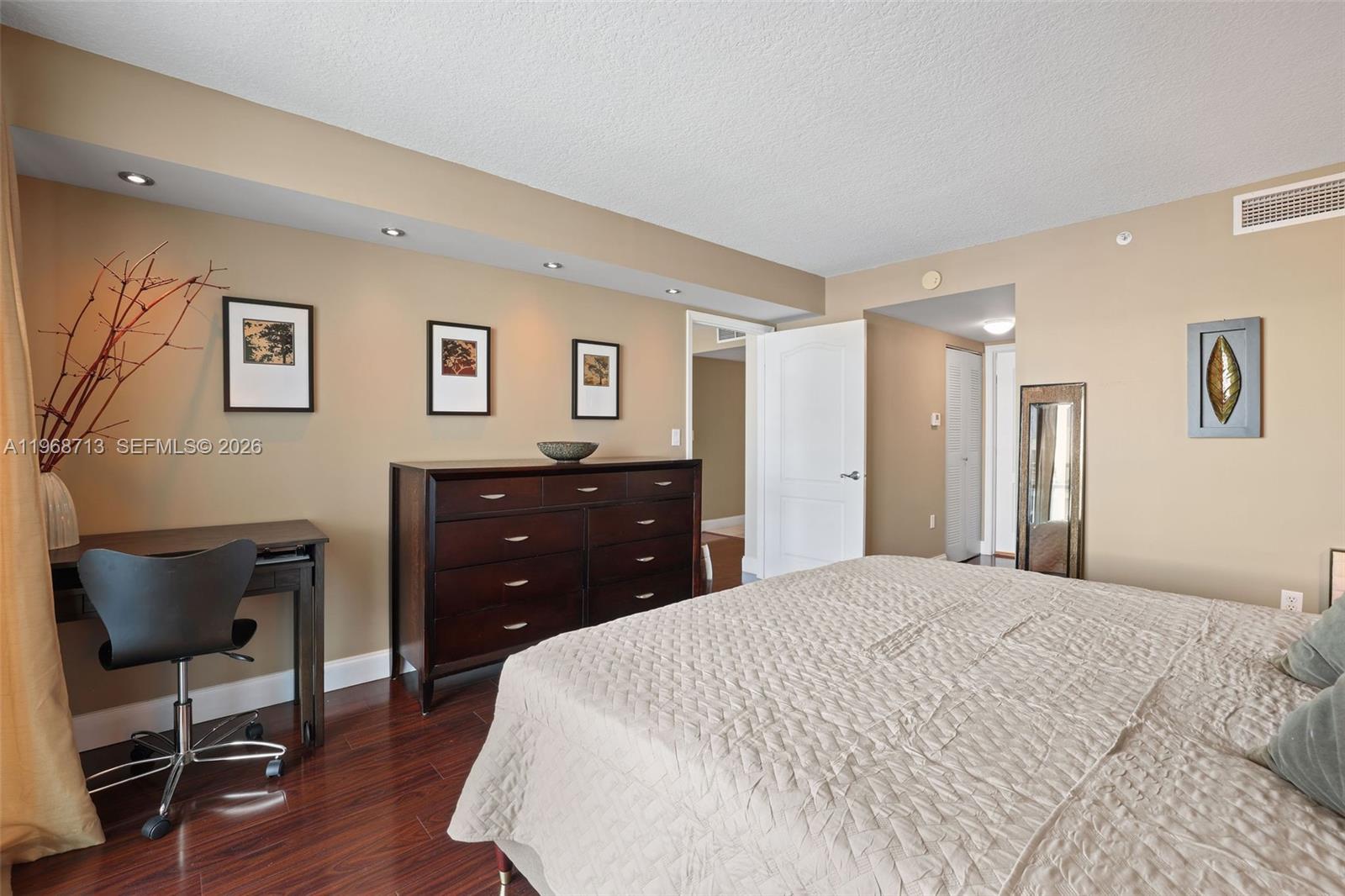 2101 Brickell Avenue, Unit 1704 Miami, FL 33129 - Photo 17 of 19 a bedroom with a bed and a chair
