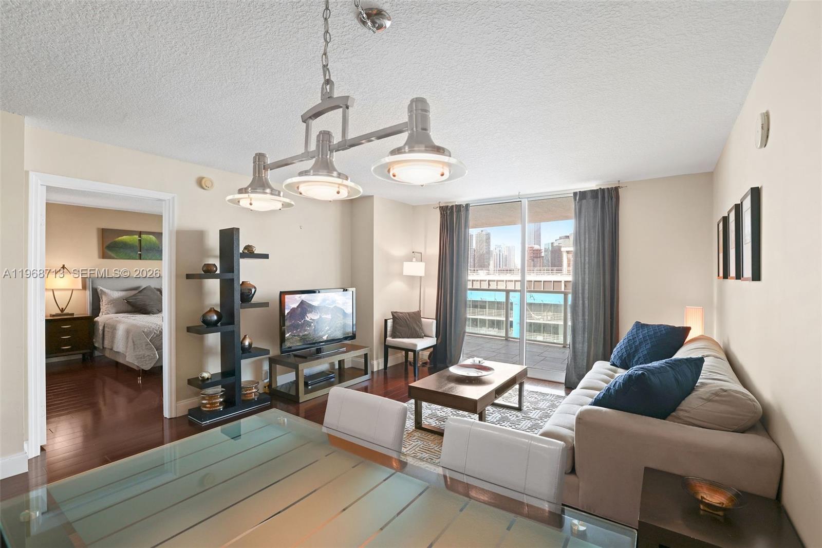 2101 Brickell Avenue, Unit 1704 Miami, FL 33129 - Photo 9 of 19 a living room with furniture and a window