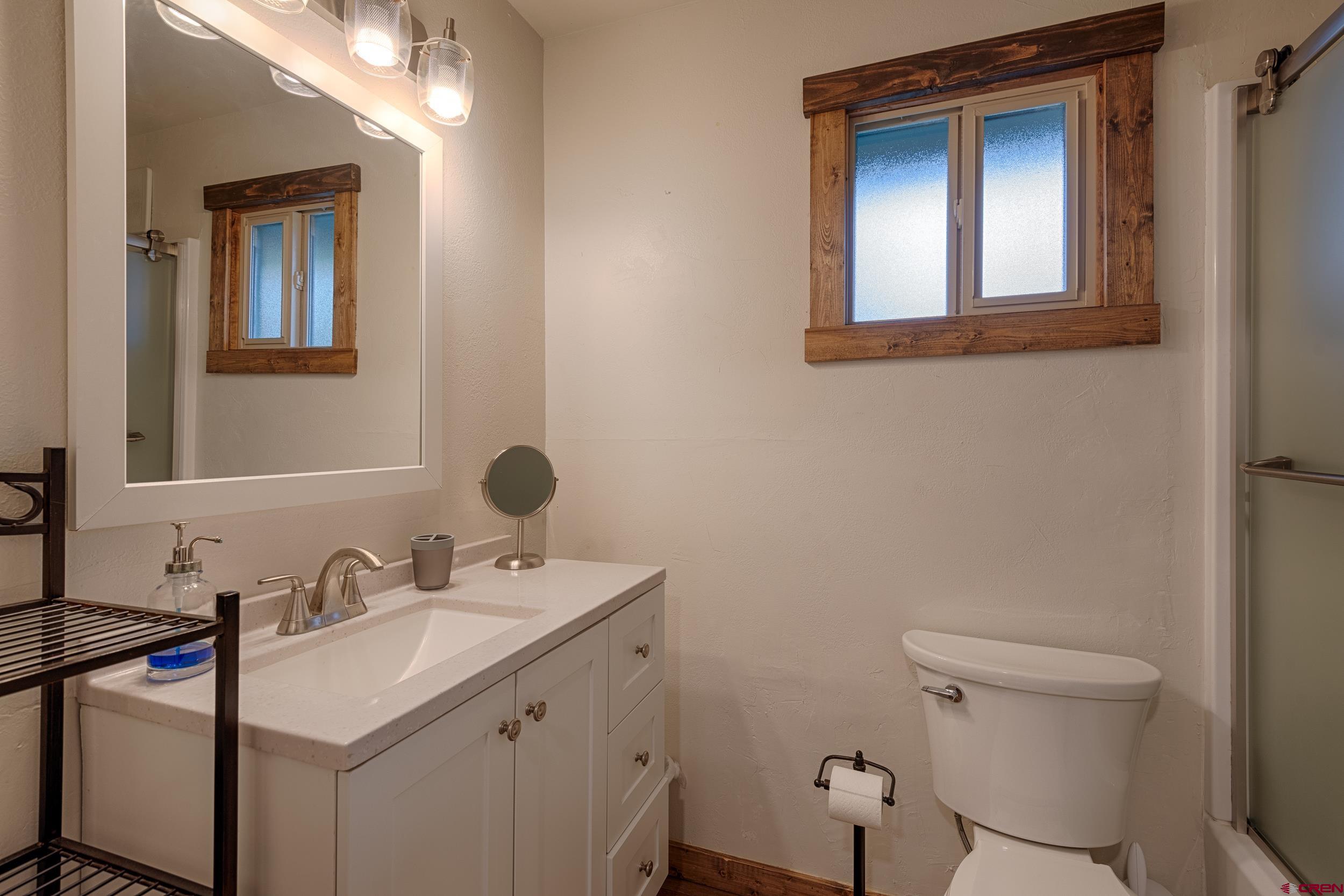 559 Suzanne Lane Ridgway, CO 81432 - Photo 26 of 45 a bathroom with a sink toilet and mirror