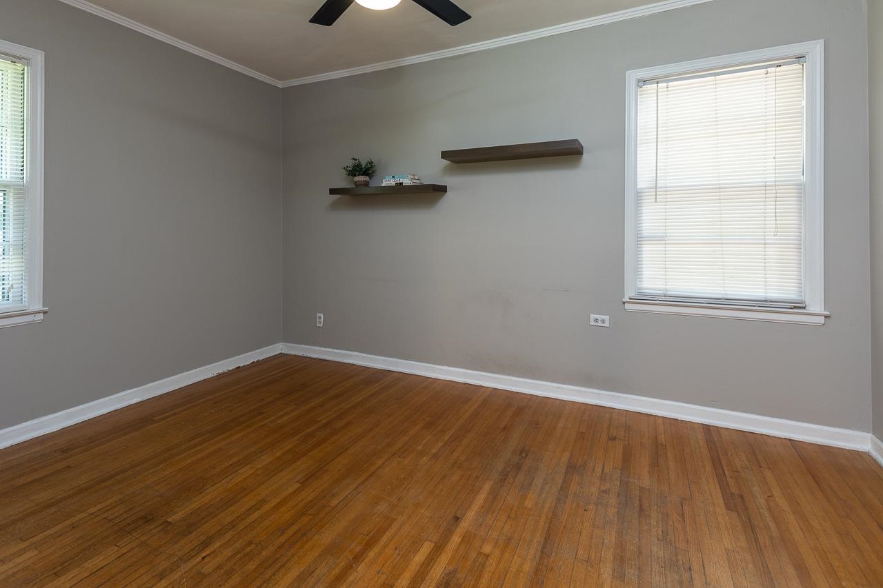 1604 Dearing Road Memphis, TN 38117 - Photo 13 of 18 an empty room with wooden floor and windows