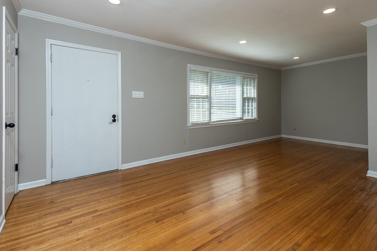 1604 Dearing Road Memphis, TN 38117 - Photo 3 of 18 a view of an empty room with wooden floor and a window