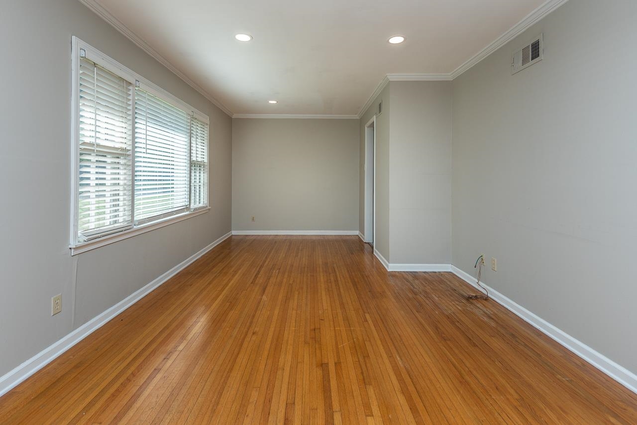 1604 Dearing Road Memphis, TN 38117 - Photo 4 of 18 a view of empty room with wooden floor and fan