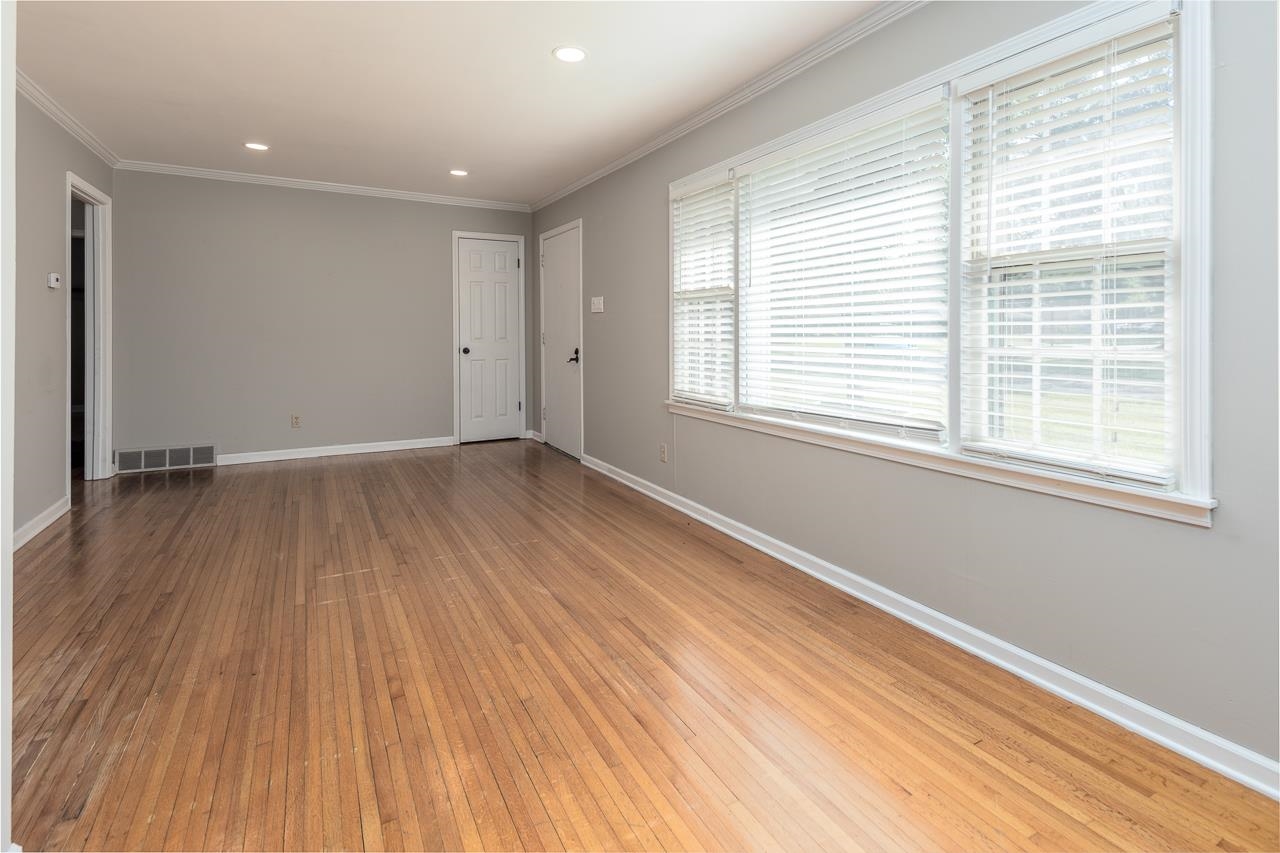 1604 Dearing Road Memphis, TN 38117 - Photo 5 of 18 an empty room with wooden floor and windows