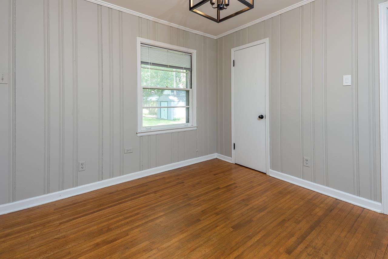 1604 Dearing Road Memphis, TN 38117 - Photo 10 of 18 an empty room with wooden floor and windows