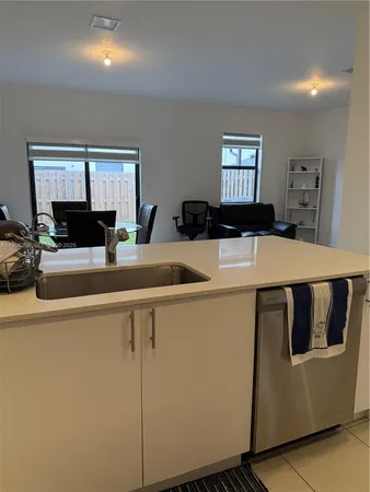 a kitchen with stainless steel appliances a white stove top oven sink and cabinets