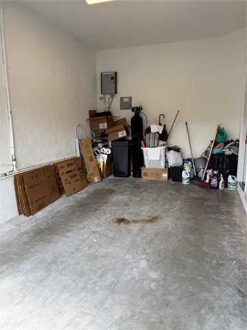 a living room with furniture and floor to ceiling window