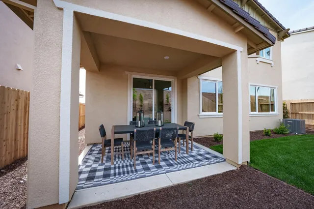 a view of a patio with table and chairs