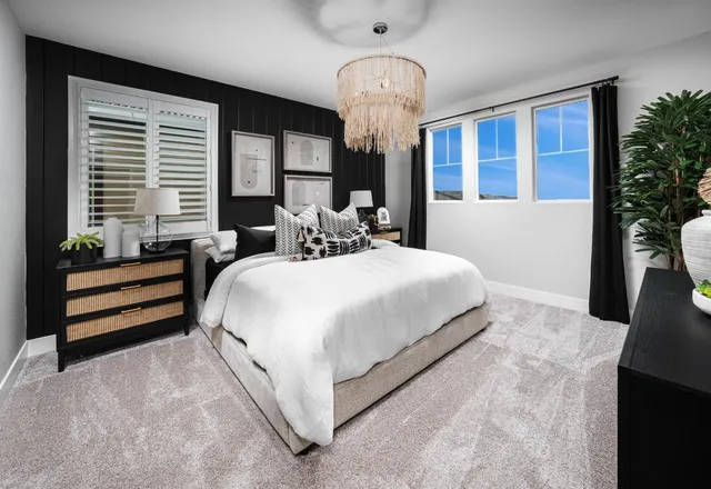 a bedroom with bed and large windows