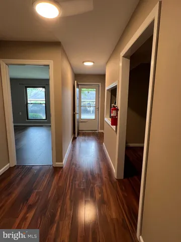 a view of a hallway view with wooden floor and staircase