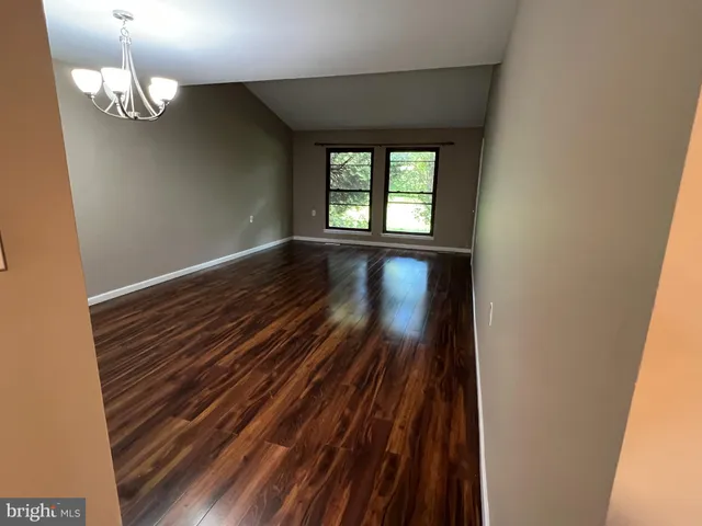 a view of room with wooden floor