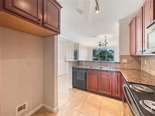 a kitchen with stainless steel appliances granite countertop a sink and cabinets