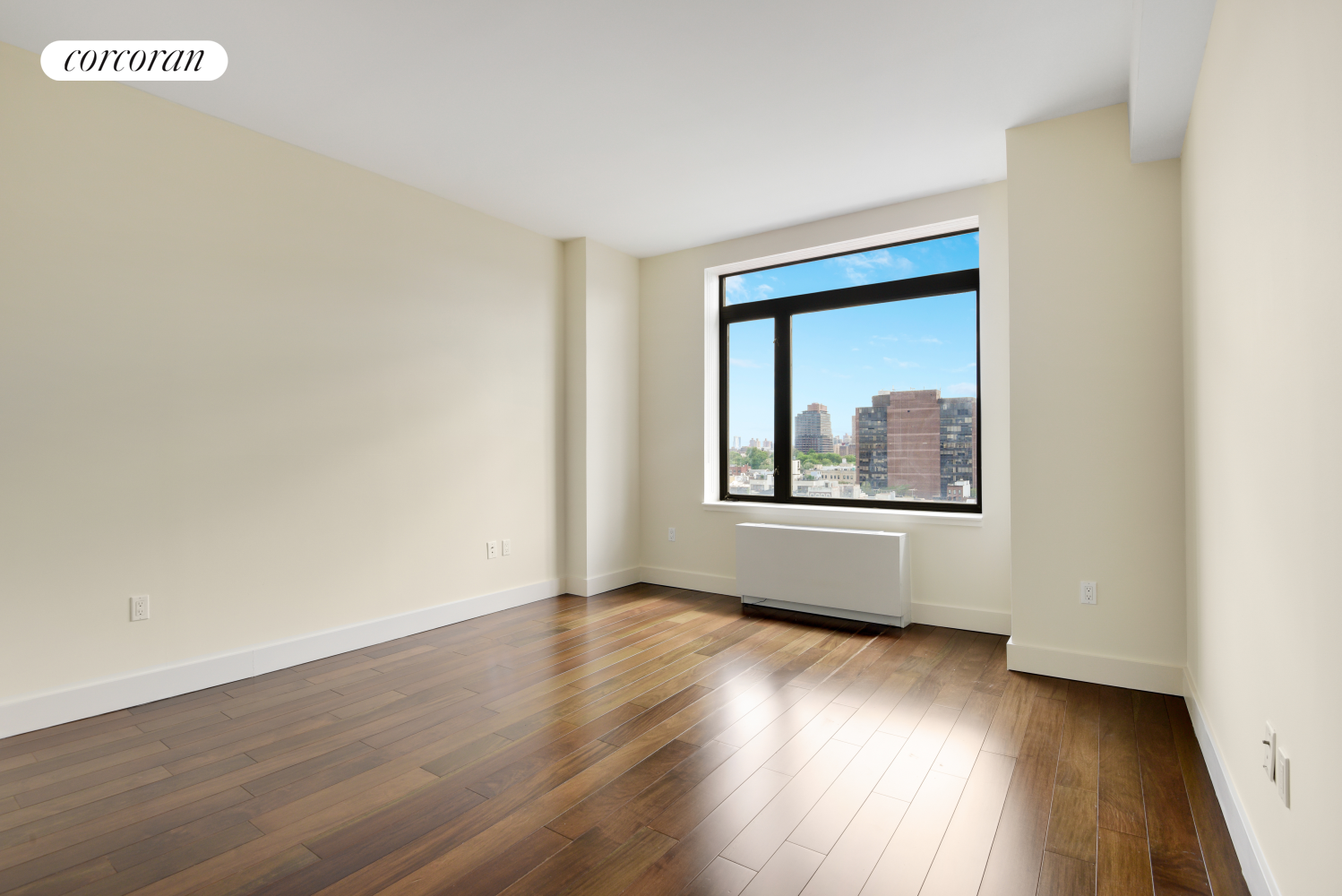 380 Lenox Avenue, Unit PHC Manhattan, NY 10027 - Photo 6 of 15 a view of an empty room with wooden floor and a window