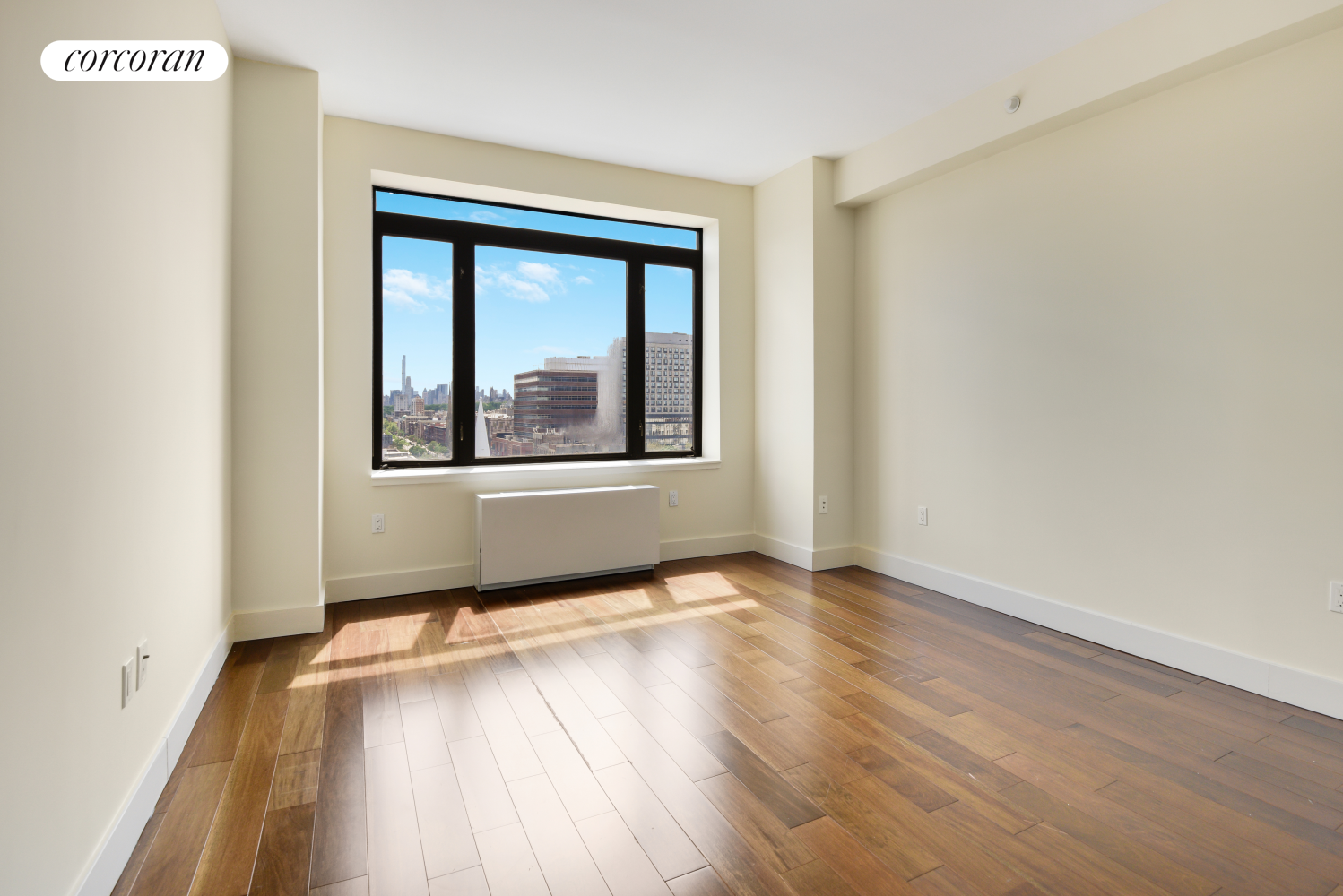 380 Lenox Avenue, Unit PHC Manhattan, NY 10027 - Photo 8 of 15 a view of an empty room with wooden floor and a window
