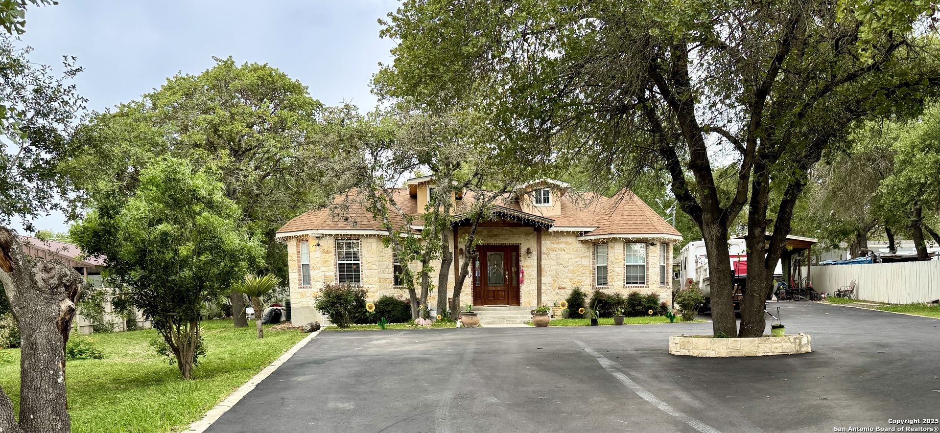 a front view of a house with a garden