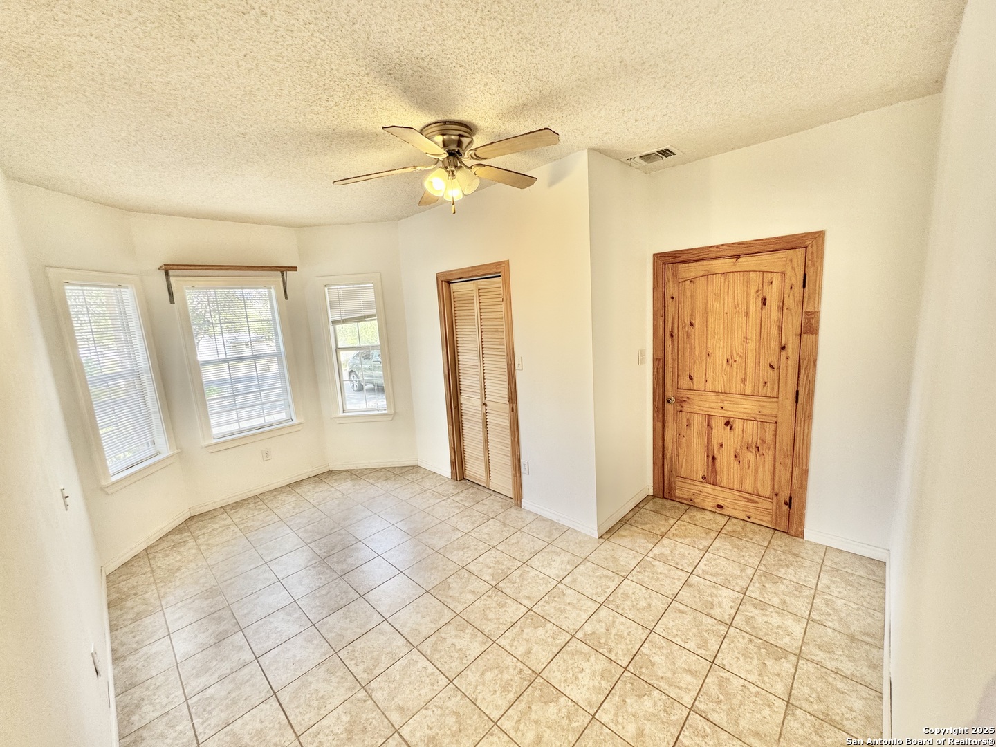 22739 Lazy Stream Drive Elmendorf, TX 78112 - Photo 13 of 20 a view of an empty room with cabinet and a window