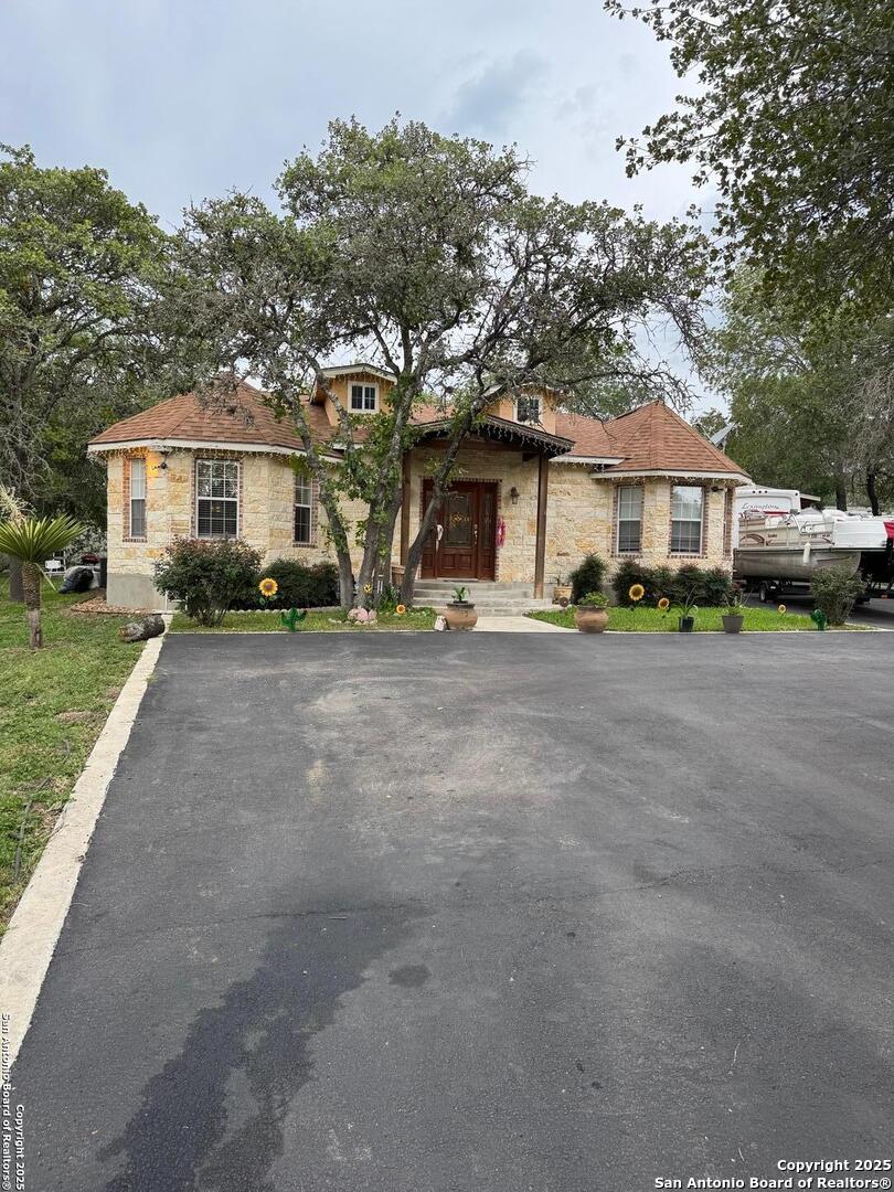 22739 Lazy Stream Drive Elmendorf, TX 78112 - Photo 18 of 20 a front view of a house with a yard