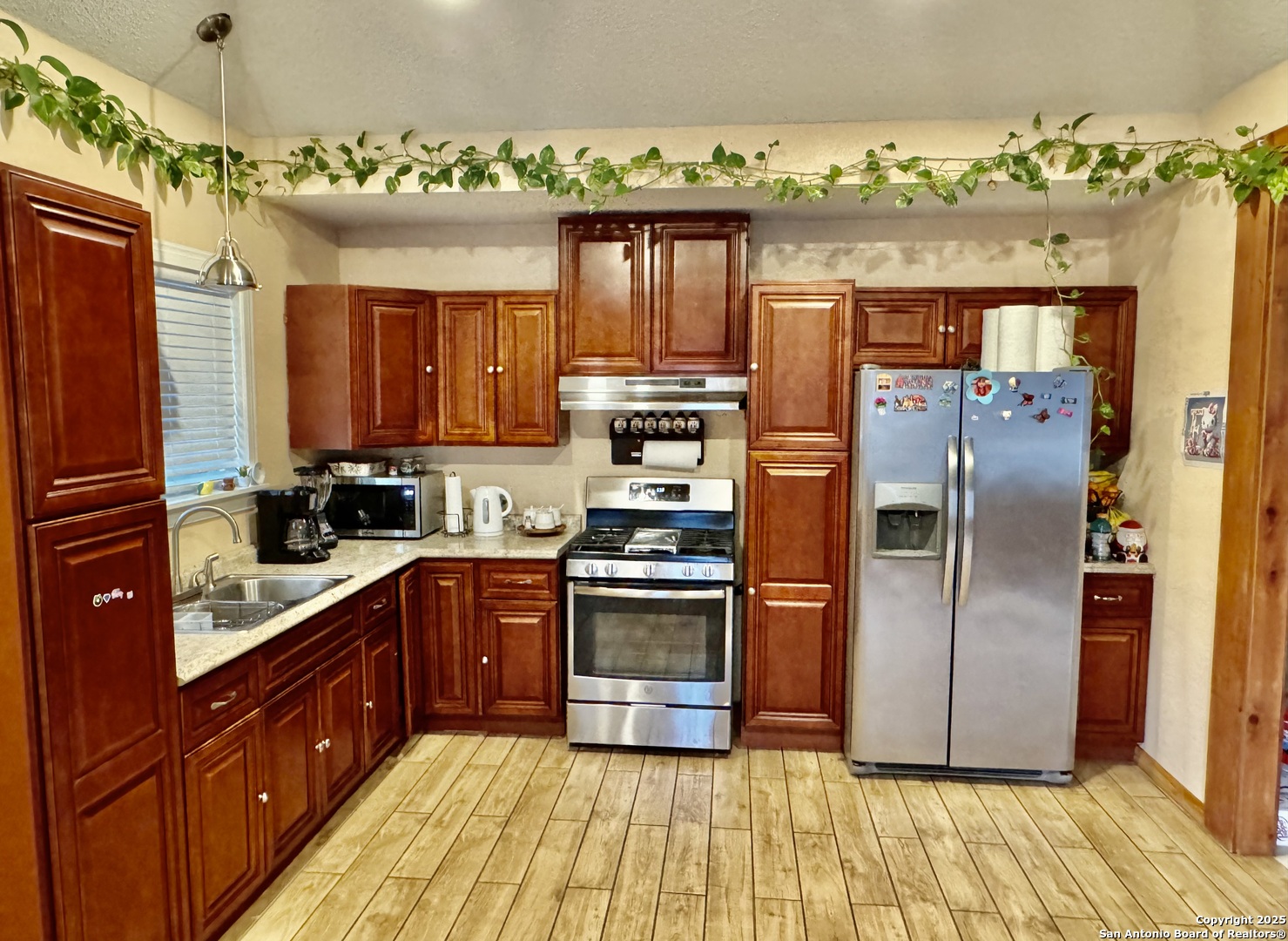 22739 Lazy Stream Drive Elmendorf, TX 78112 - Photo 3 of 20 a kitchen with stainless steel appliances granite countertop a refrigerator and a stove