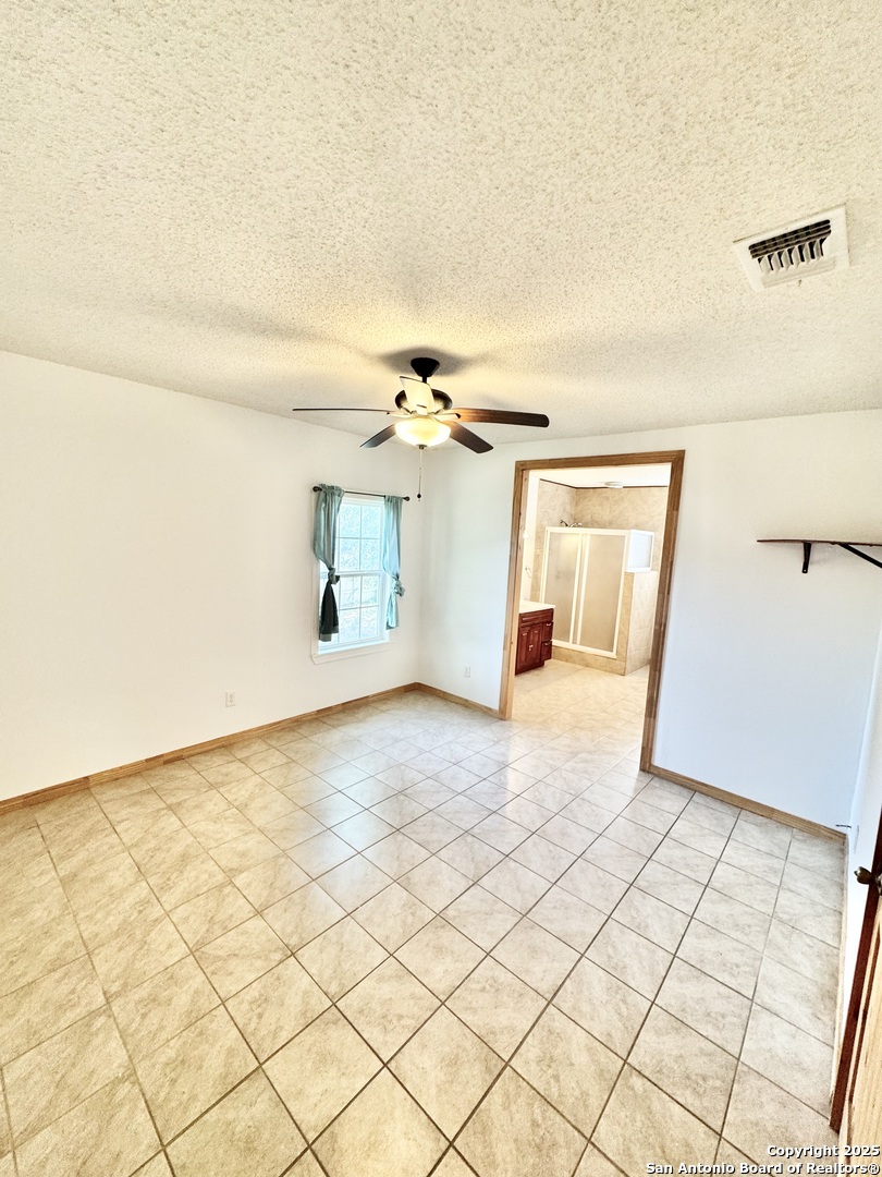22739 Lazy Stream Drive Elmendorf, TX 78112 - Photo 9 of 20 a view of a livingroom and a bathroom