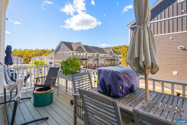 a view of a balcony with chair and wooden floor