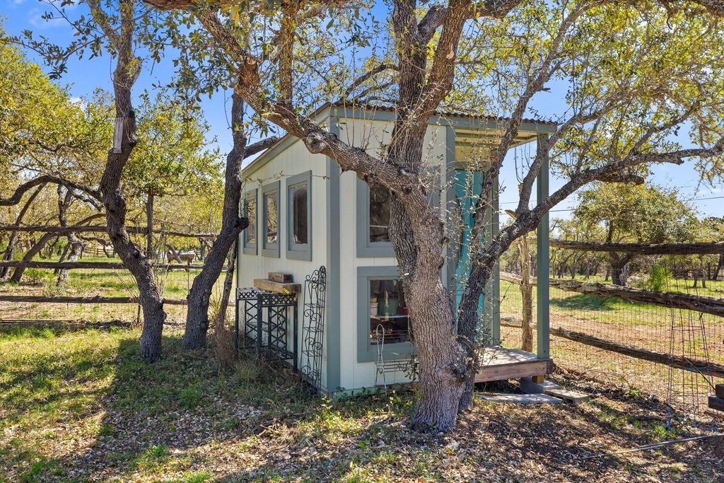 290 Sunset Ridge Dripping Springs, TX 78620 - Photo 22 of 39 a front view of a house with a yard