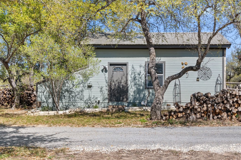 290 Sunset Ridge Dripping Springs, TX 78620 - Photo 31 of 39 a view of a house with a yard