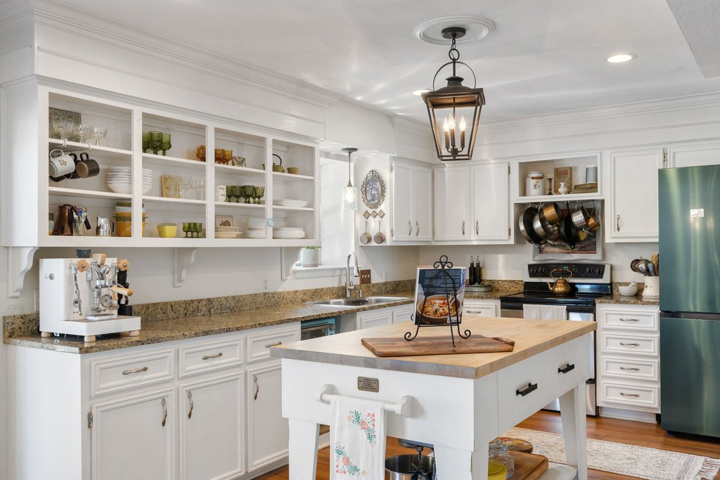 290 Sunset Ridge Dripping Springs, TX 78620 - Photo 6 of 39 Kitchen with open shelves, white cabinetry, freestanding refrigerator, and dark stone counters