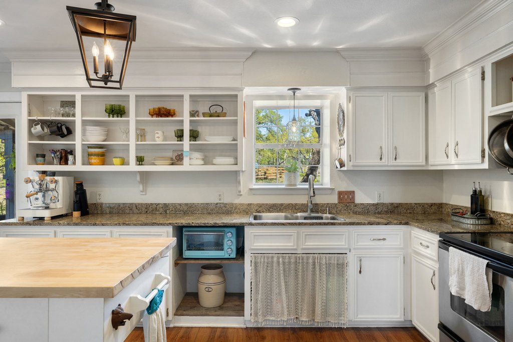 290 Sunset Ridge Dripping Springs, TX 78620 - Photo 9 of 39 Kitchen featuring white cabinetry, stainless steel electric range oven, open shelves, butcher block countertops, and dark wood-type flooring