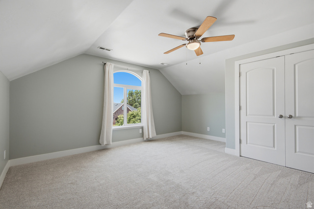 1252 Skyline Road Saratoga Springs, UT 84045 - Photo 30 of 51 Spacious room featuring vaulted ceilings, light gray wall paint, and plush carpeting