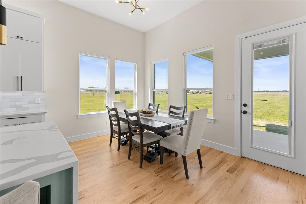 1568 County Road 3517 Quinlan, TX 75474 - Photo 11 of 30 a view of a dining room with furniture and wooden floor