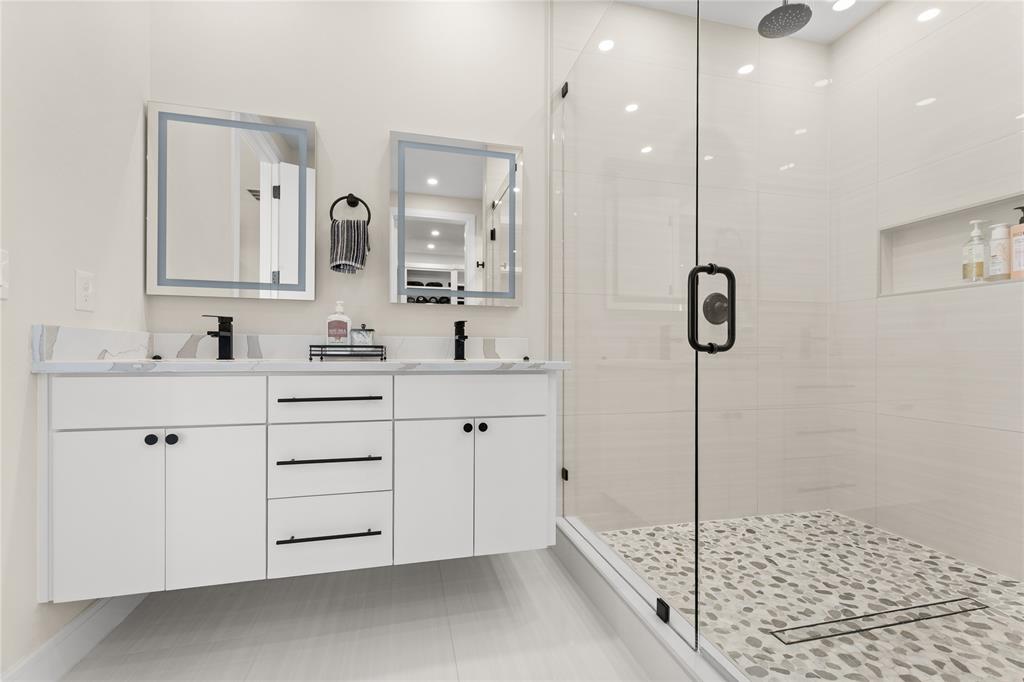 1568 County Road 3517 Quinlan, TX 75474 - Photo 17 of 30 a bathroom with a double vanity sink a mirror and a shower
