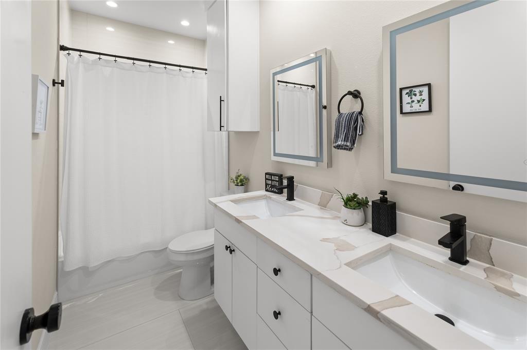 1568 County Road 3517 Quinlan, TX 75474 - Photo 22 of 30 a bathroom with a double vanity sink toilet and mirror