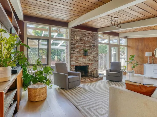 a living room with furniture and a potted plant