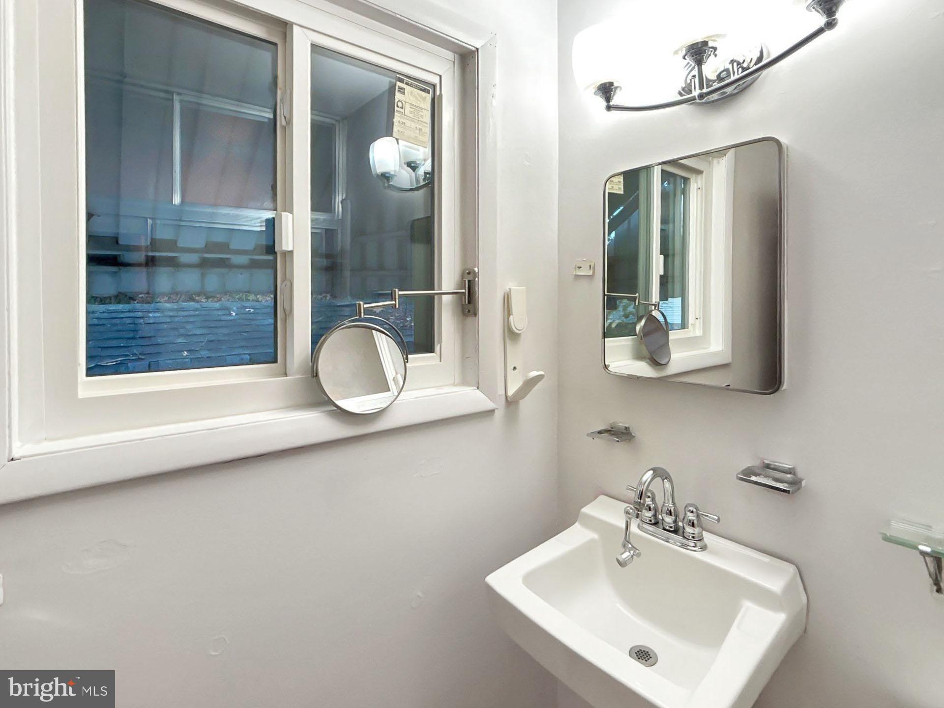 3323 Nash Place Southeast Washington, DC 20020 - Photo 12 of 23 a bathroom with a sink mirror and vanity