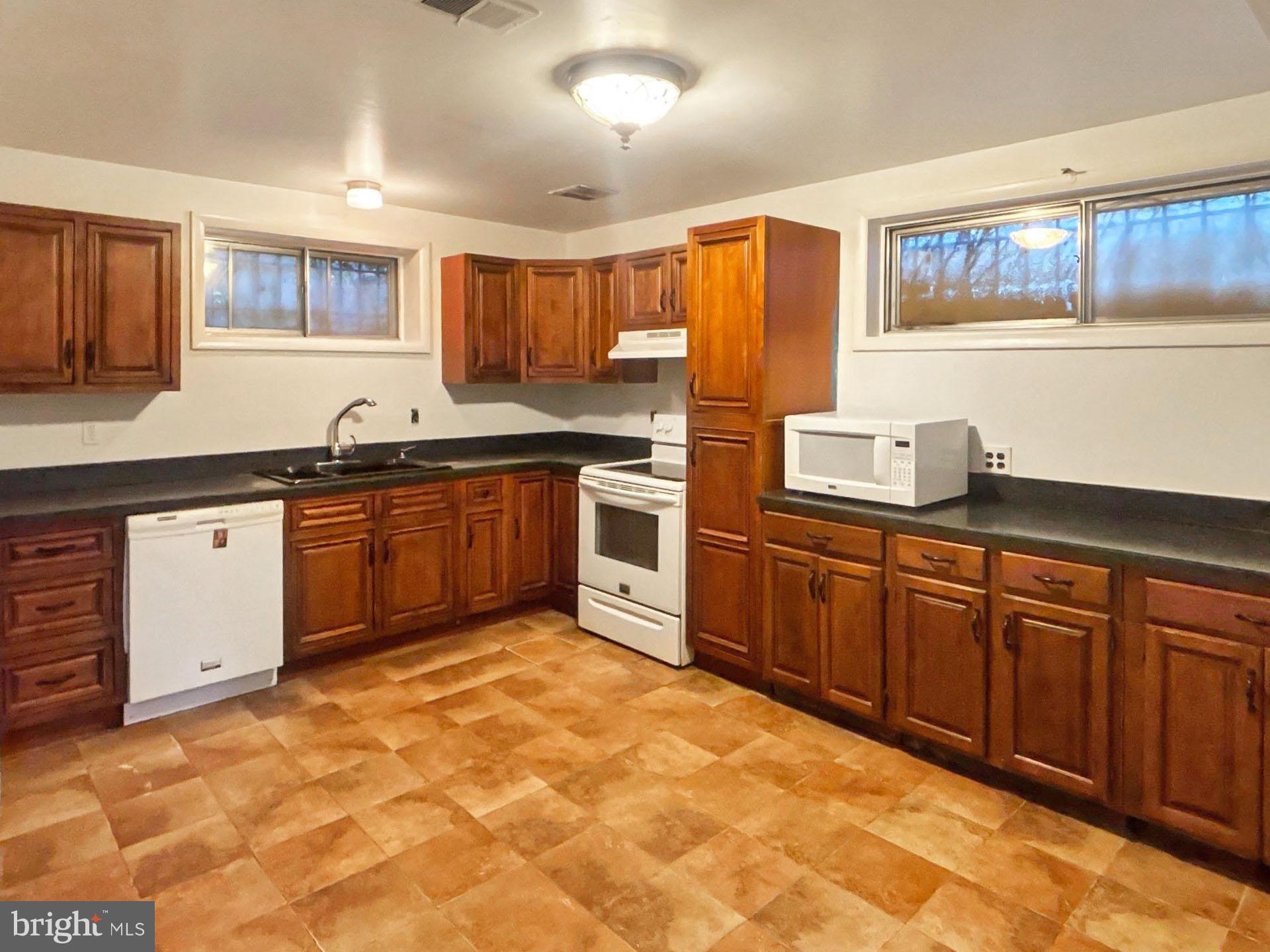 3323 Nash Place Southeast Washington, DC 20020 - Photo 17 of 23 a kitchen with stainless steel appliances granite countertop a stove sink and cabinets