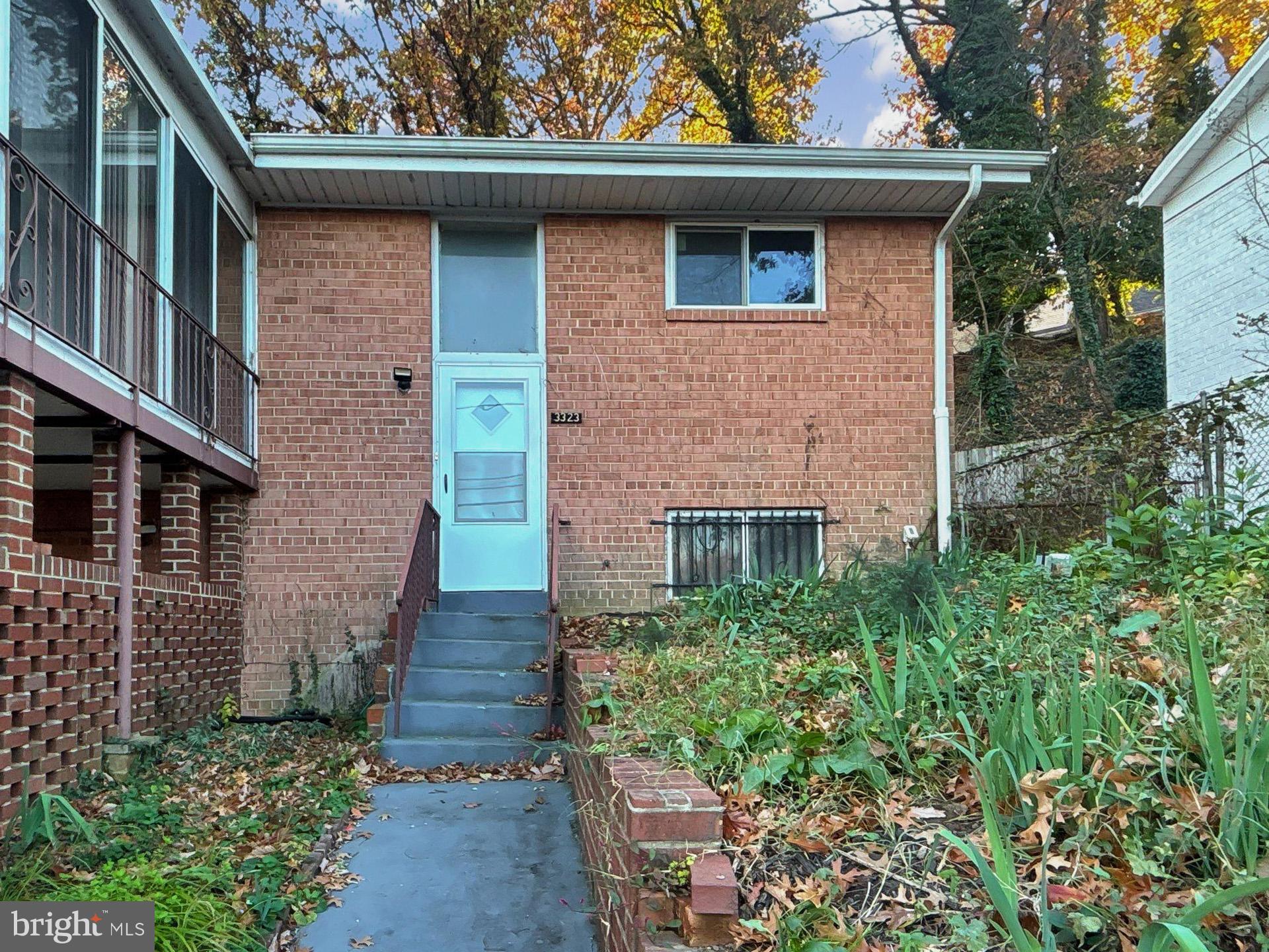 3323 Nash Place Southeast Washington, DC 20020 - Photo 2 of 23 a front view of a house with brick walls