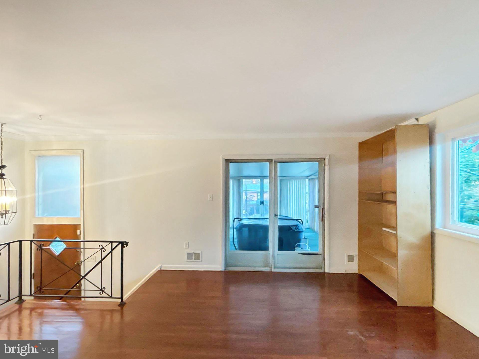 3323 Nash Place Southeast Washington, DC 20020 - Photo 5 of 23 an empty room with wooden floor and windows