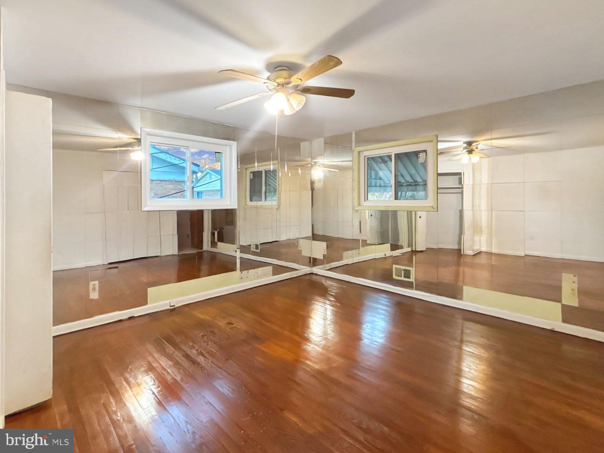 3323 Nash Place Southeast Washington, DC 20020 - Photo 10 of 23 an empty room with wooden floor and windows